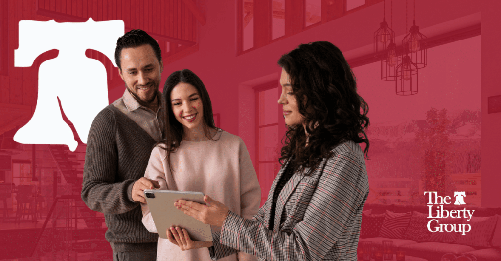 Three property management professionals look into a tablet; The Liberty Group logo is in the background.