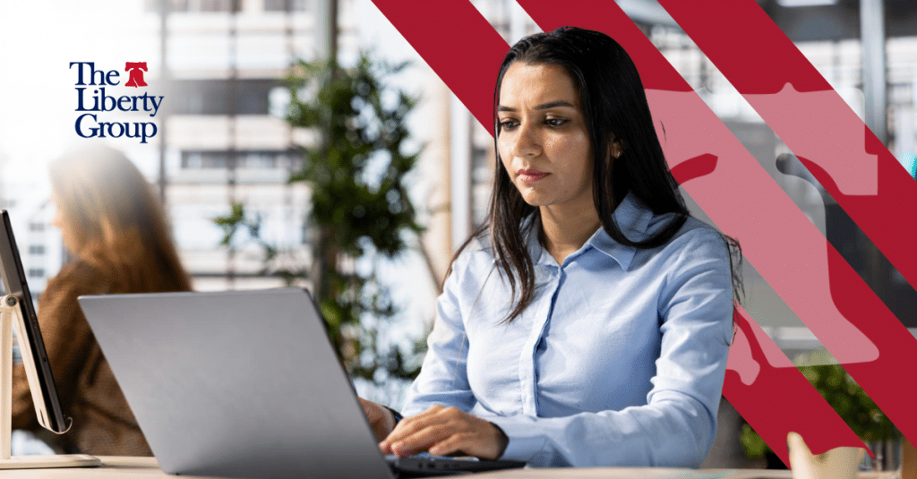 Property management professional working on laptop in modern office.