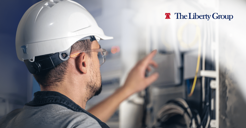 Maintenance technician inspecting equipment for The Liberty Group.