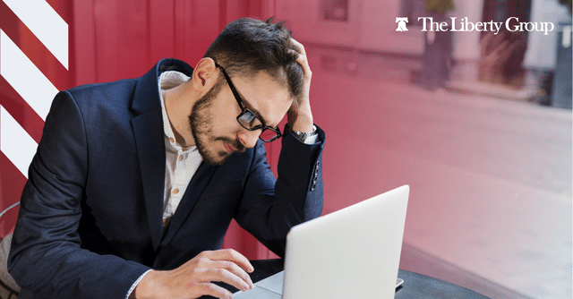 Property manager reviewing resumes to prevent the cost of a bad hire.